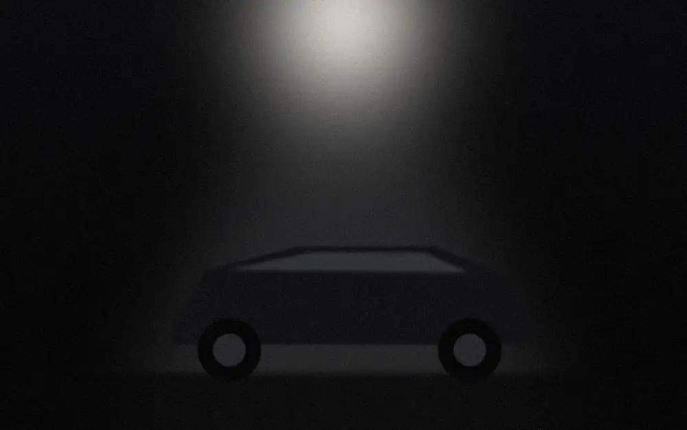 Placeholder photo: a coupe parked under a single streetlight.